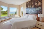 The master bedroom, upstairs, offers views of the bay and golf course